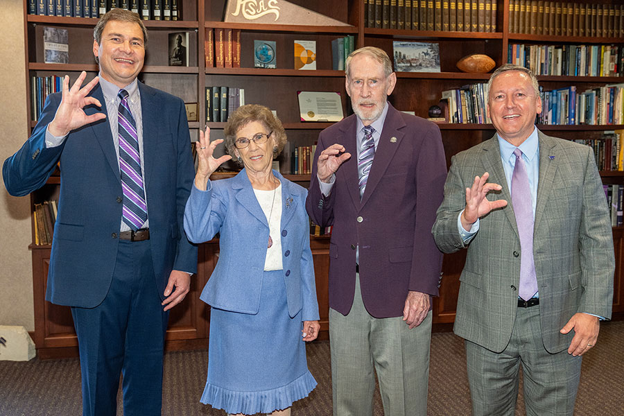 Dr. Hans Coetzee with Ron and Rae Iman and K-State President Richard Linton