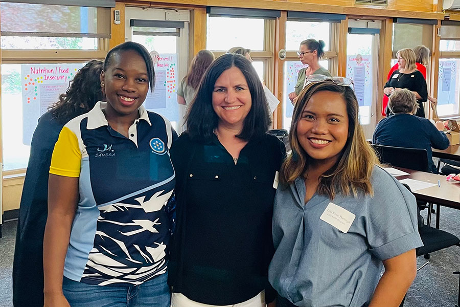 K-State Master of Public Health students Nokwanda Hlophe, left, and Toni Rose Barroga, right, attend the 2022 Riley County Community Health Improvement Plan meeting with Ellyn Mulcahy, center, director of the university's Master of Public Health Program. 