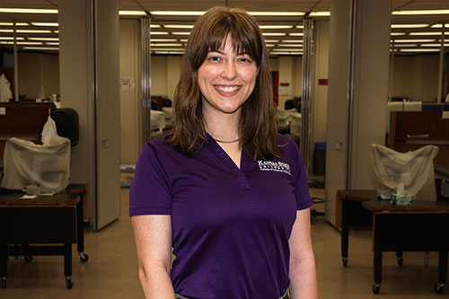 Female student stands in middle of laboratory