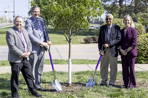 President Linton, Dr. Hans Coatzee, Dr. T.G. Nagaraja and interim dean Elizabeth Davis standing around a newly planted tree.