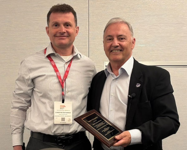 Dr. Christos Katsanos presents plaque to Dr. David Poole