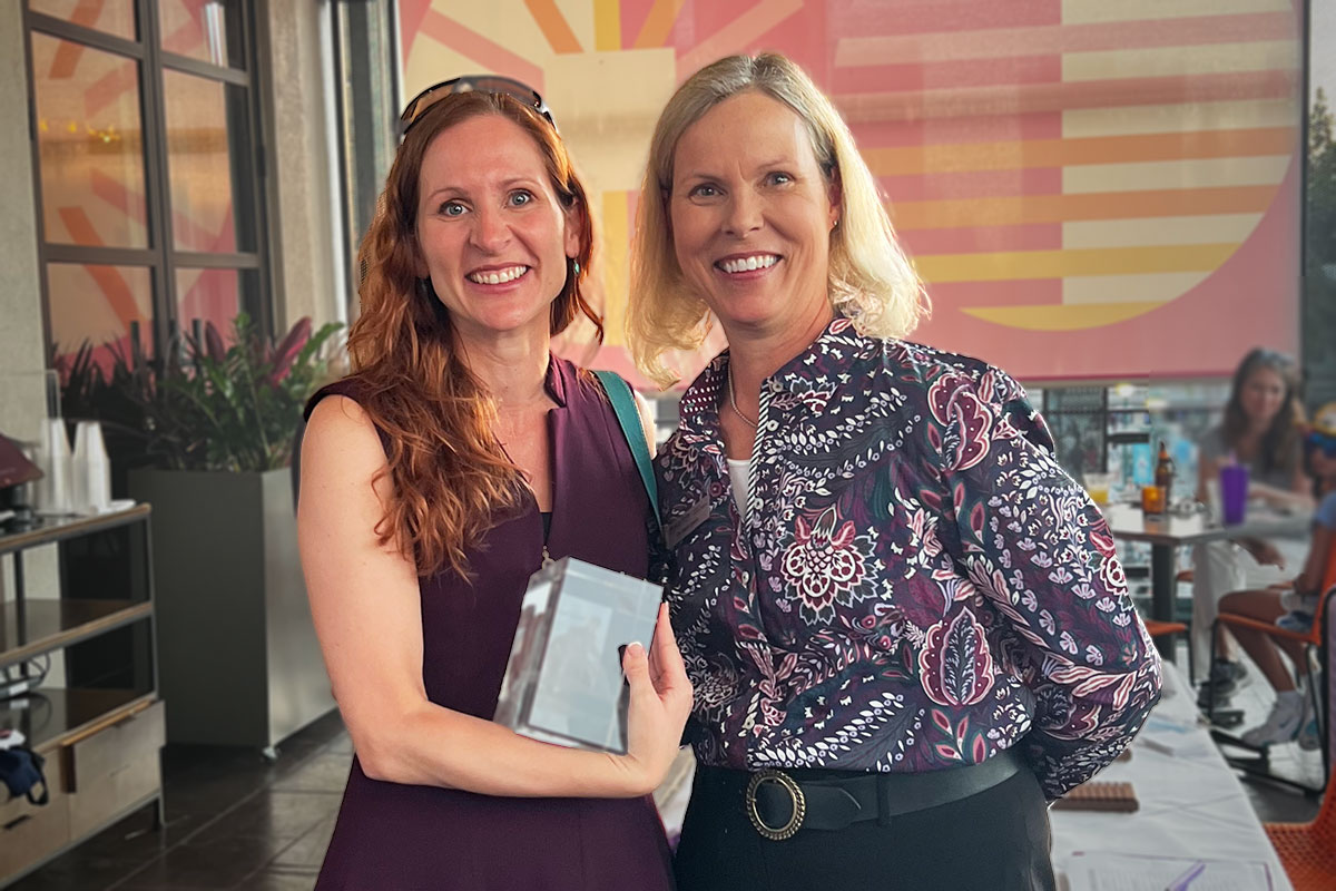 Dr. Colleen Lambo receives an alumni recognition award from Interim Dean Dr. Elizabeth Davis