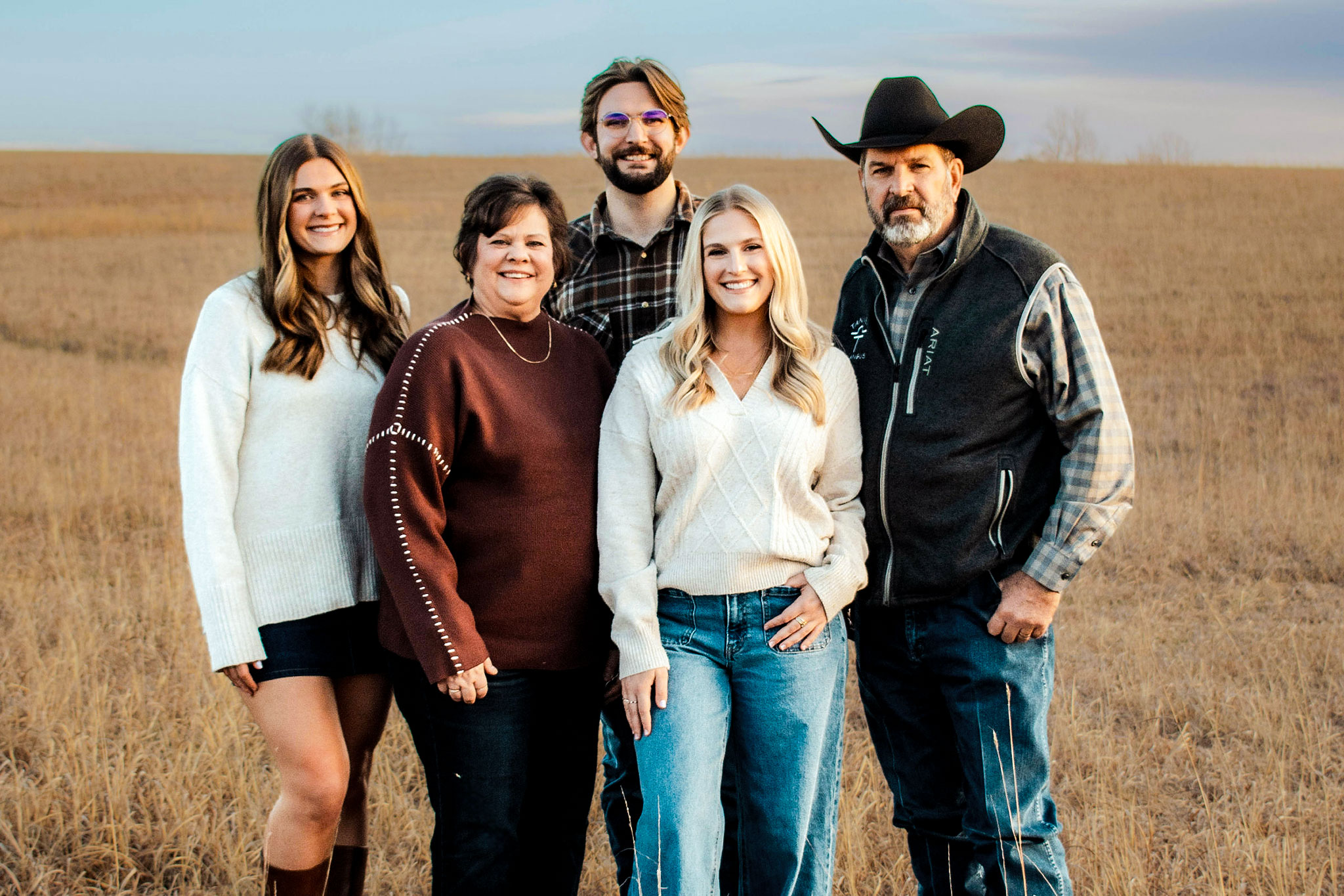 Family of five stands out in a wheat field