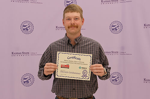 Student holds scholarship certificate