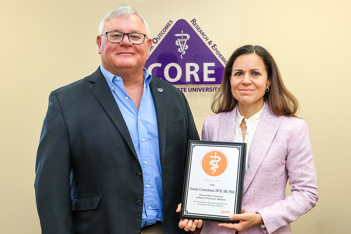 Two people standing with one holding a plaque