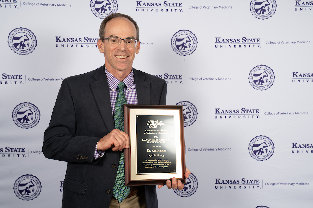 Dr. Kenneth Harkin holds plaque from AAVC