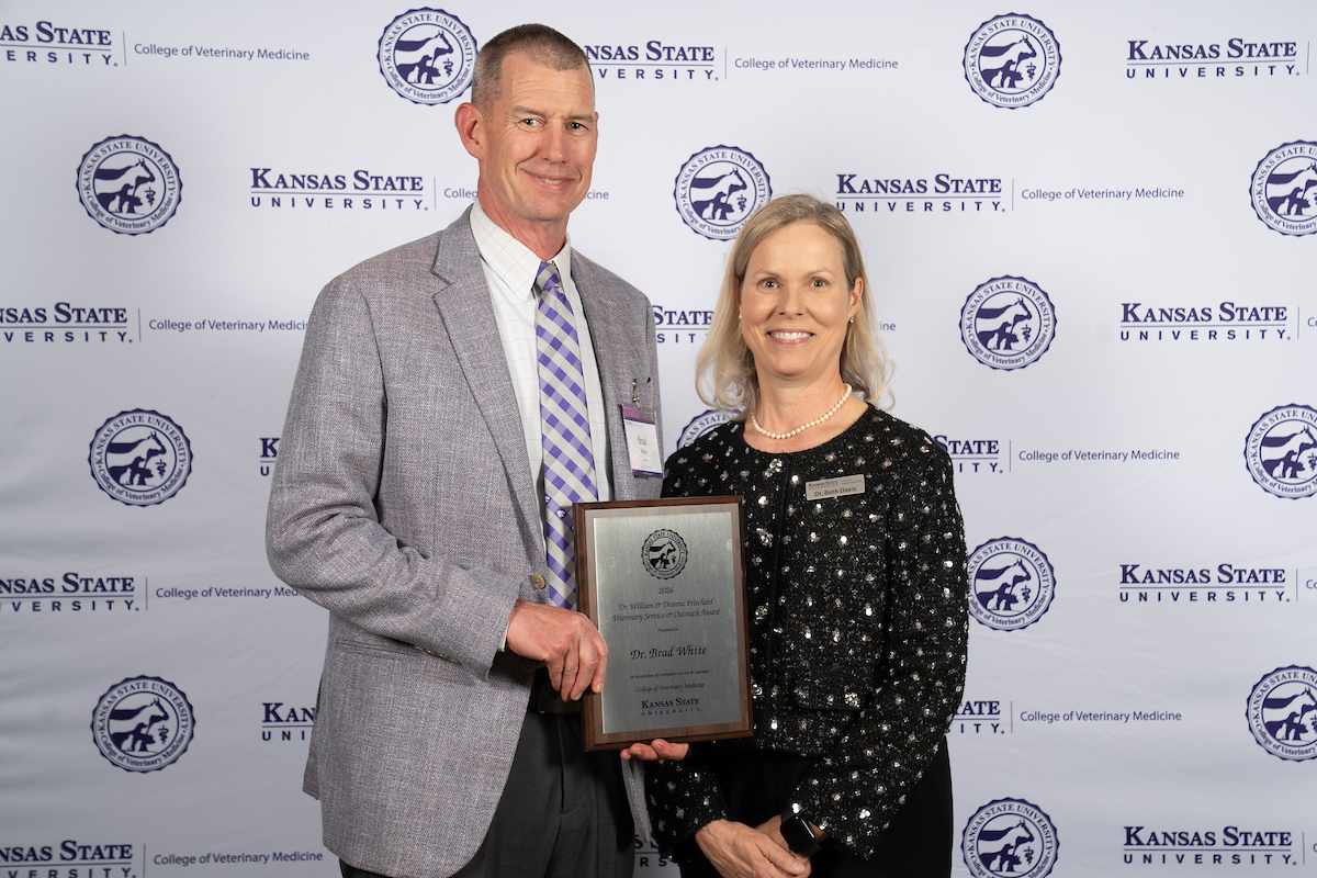 Dr. Brad White accepts the Pritchard Award from Interim Dean Dr. Elizabeth Davis