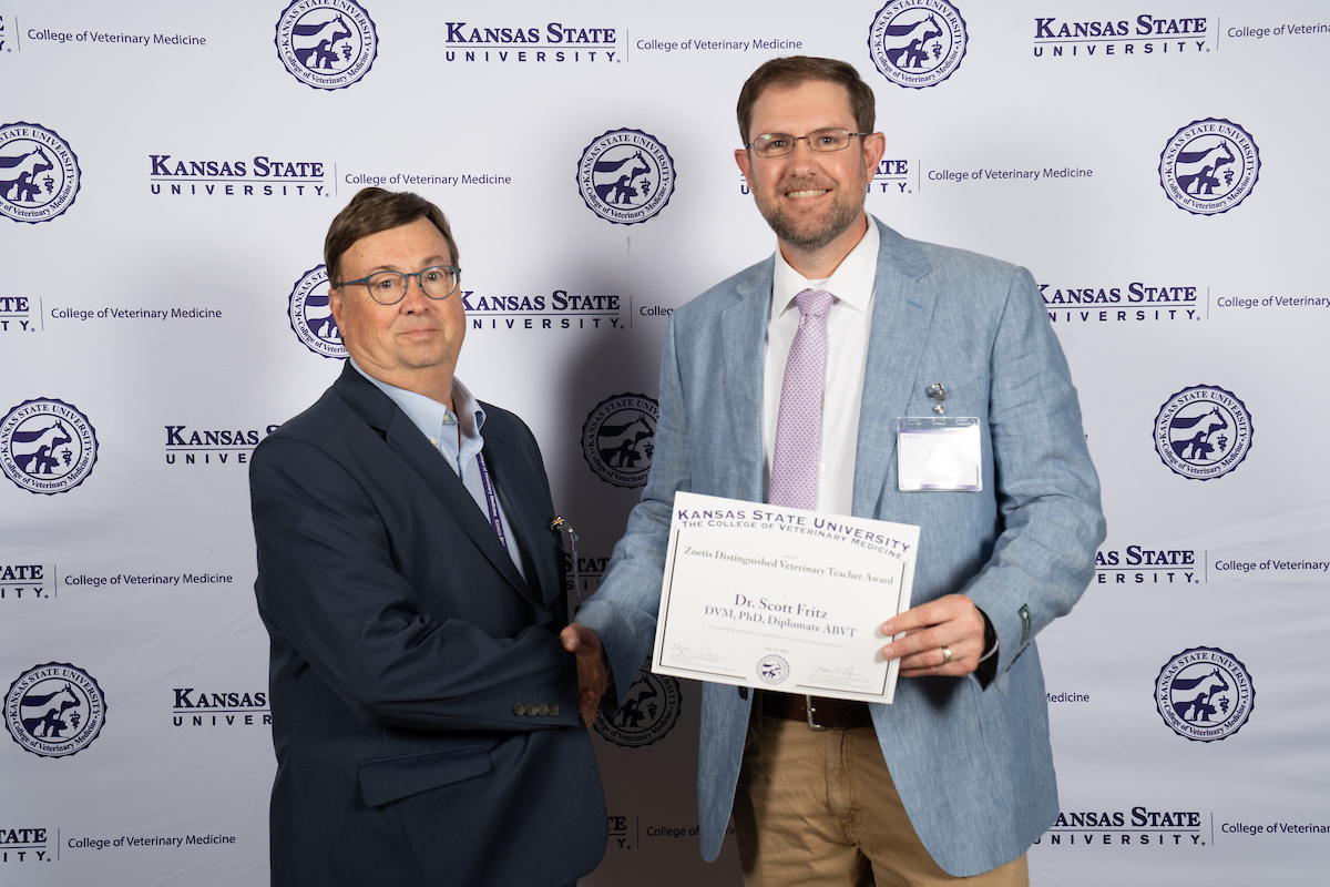 Dr. James Roush congratulates Dr. Scott Fritz on being selected for the Zoetis teaching award