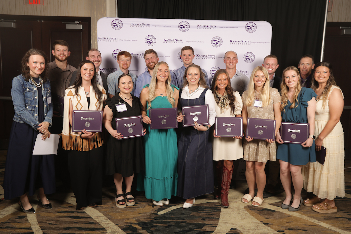 Large group of students hold certificates