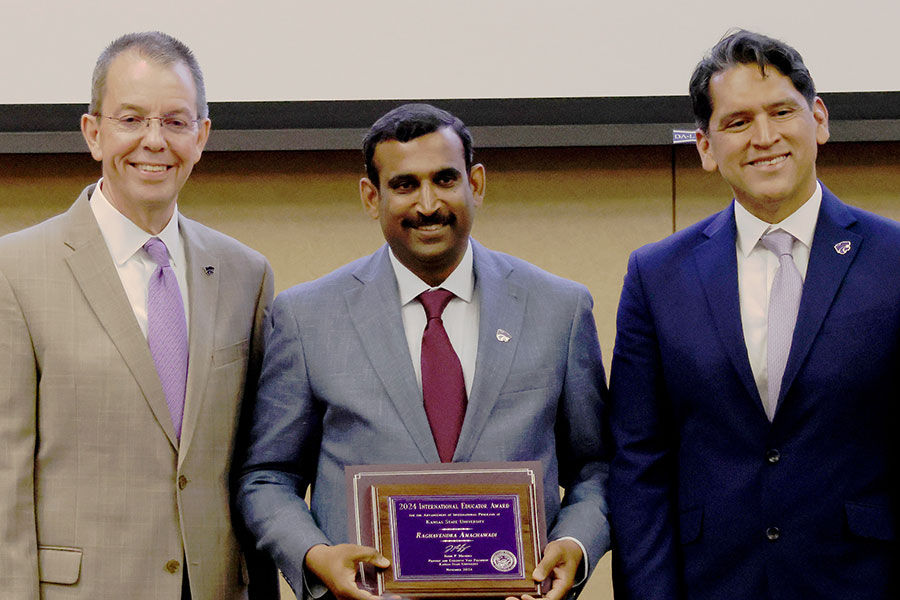 Dr. Raghavendra Amachawadi accepts award from Marshall Stewart and Jesse Mendez