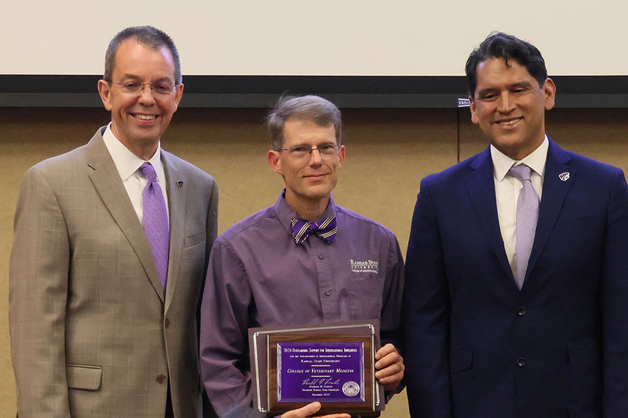Dr. Walter Renberg accepts award from Marshall Stewart and Jesse Mendez