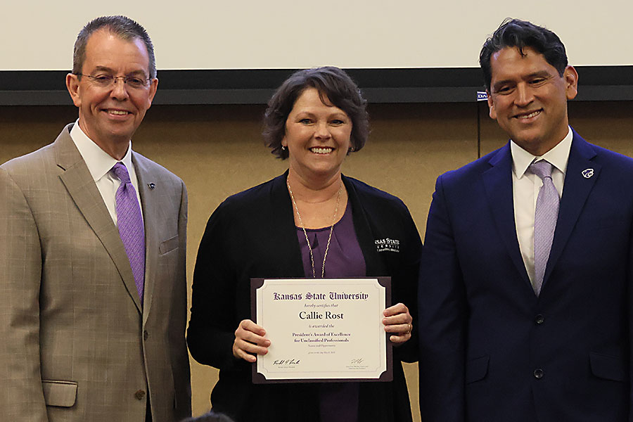 Dr. Callie Rost accepts award from Marshall Stewart and Jesse Mendez