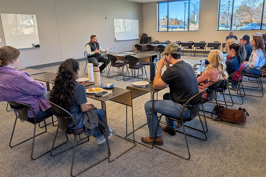 Group of students have a discussion in a classroom