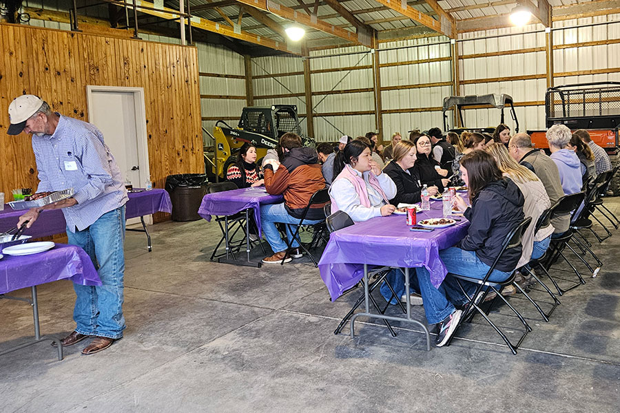 Students have barbecue inside a barn