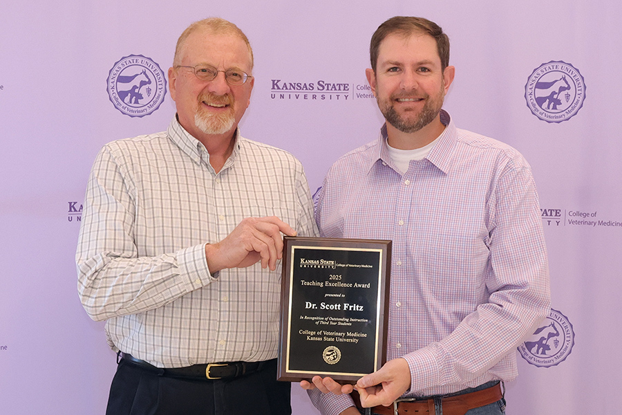 Dr. Mike Apley congratulates Dr. Scott Fritz