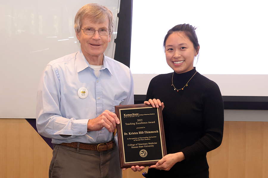 Dr. Derek Mosier congratulates Dr. Kristen Hill-Thimmesch