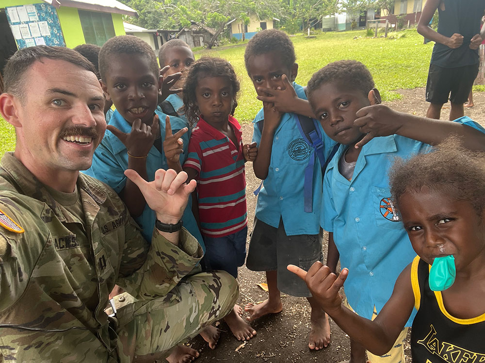 Capt. Jackson smiles with elementary school students.