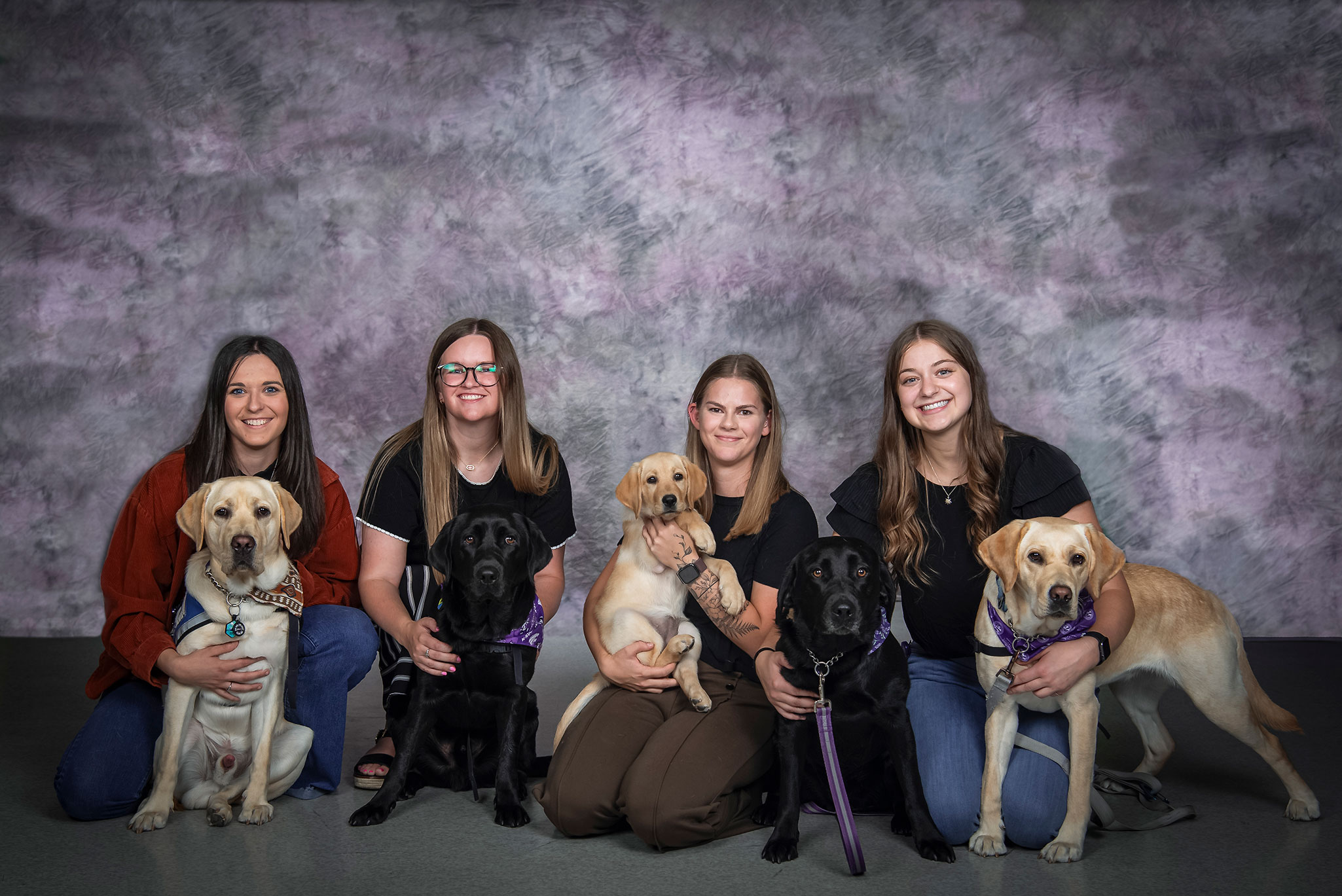 Students are posing with the dogs they are training for Ksds