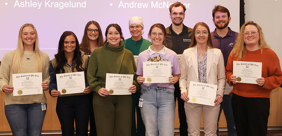 Group of students hold certificates