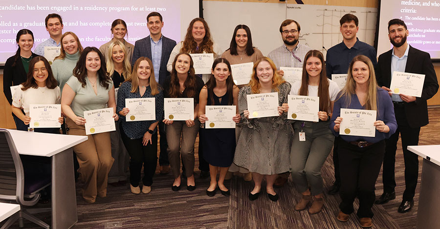 Group of students hold certificates