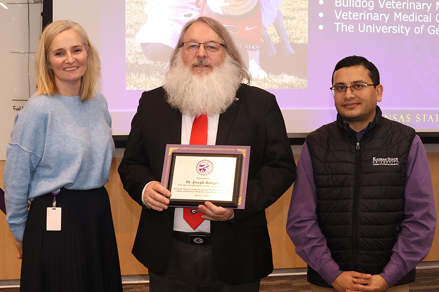 Two professors present certificate to keynote speaker