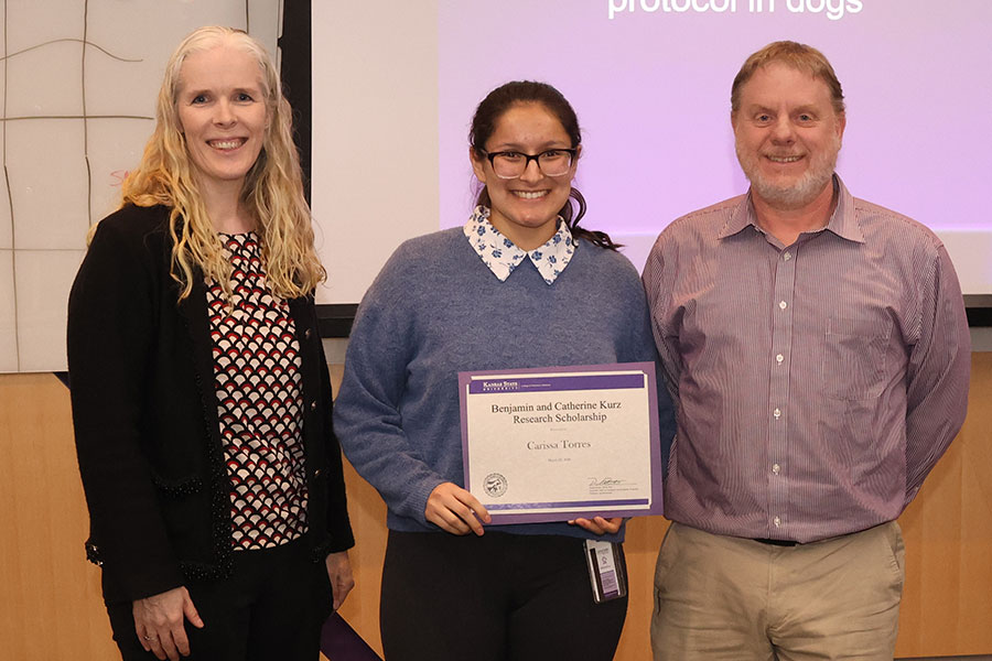 Professors present award to student