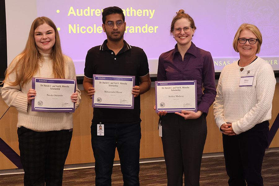 Three student scholars with a guest presenter