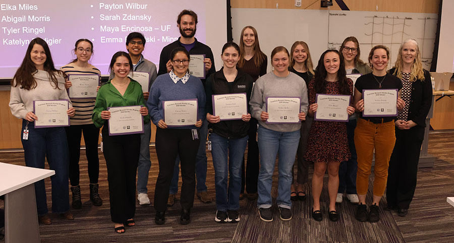 Group of students hold certificates