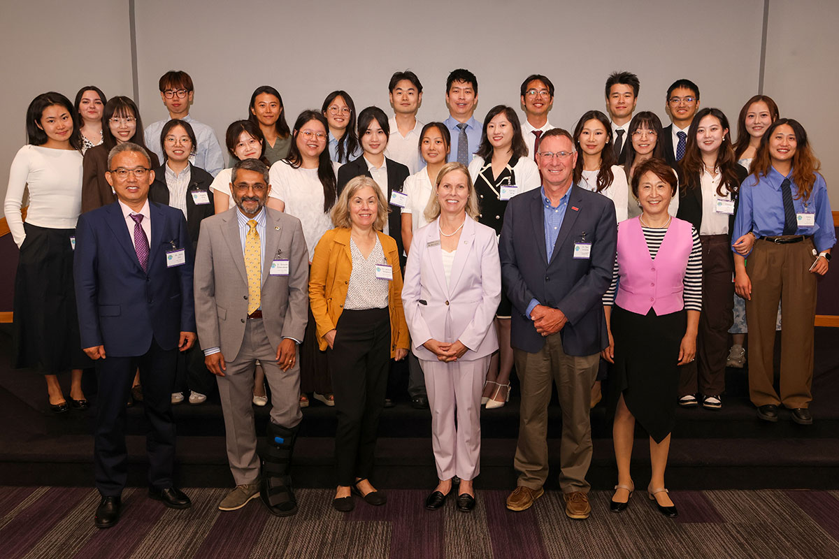 A large group of people pose for a group photo