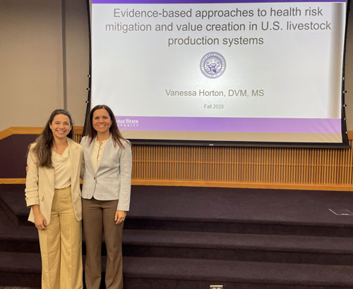 Vanessa and Dr. Cernichiarro standing together in front of a presentation scrren.