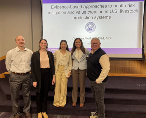 From left to right:  Dr. Glynn Tonsor, Dr. Andrea Dixon, Dr. Vanessa Horton, Dr. Natalia Cernicchiaro, and Dr. David Renter in front of a presentation screen.